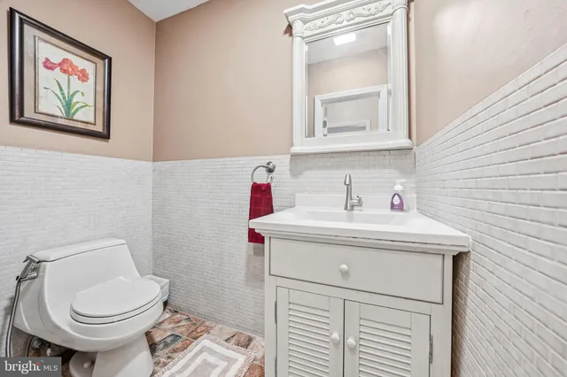 a bathroom with a toilet a sink and mirror