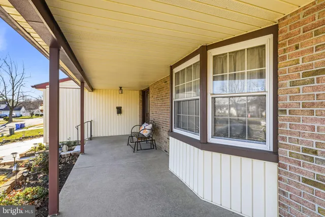 a view of a porch with chairs and backyard