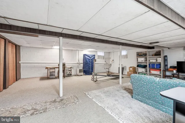 a view of a livingroom with furniture and white walls