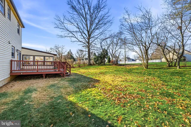 a view of a yard with a house in the background