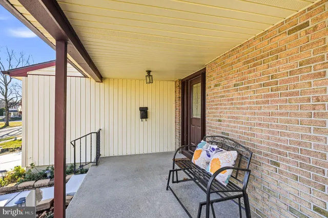a balcony with furniture and potted plants