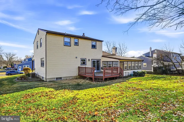 a view of a house with a big yard and sitting area