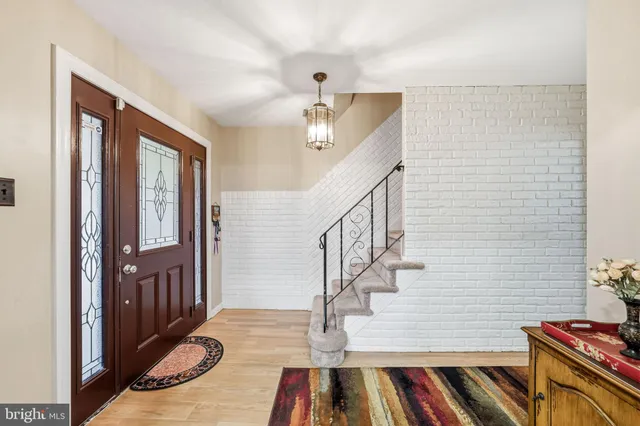a view of entryway and hall with wooden floor