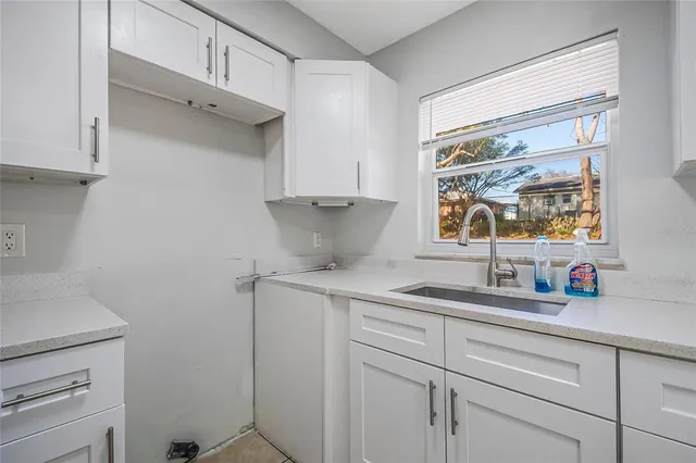 a kitchen with a sink and cabinets