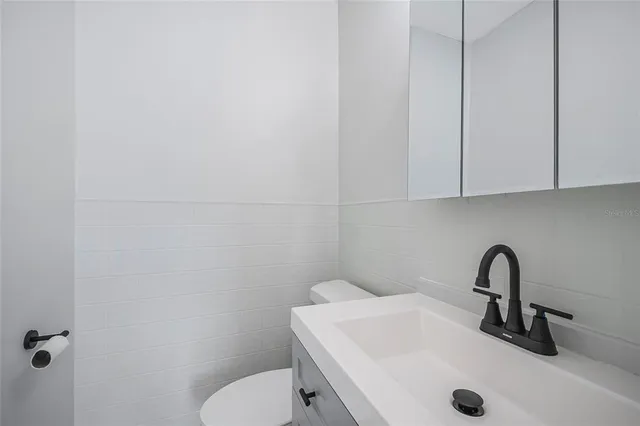 a bathroom with a sink a toilet and a tub