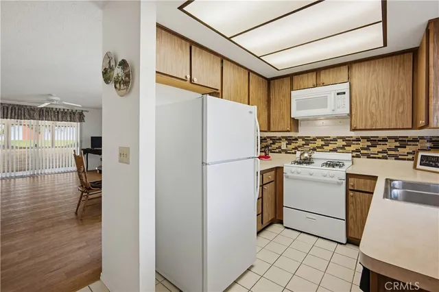 a white refrigerator freezer and a stove