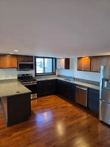 a large kitchen with a stove and a sink