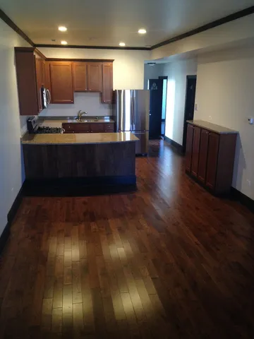 a view of kitchen with cabinets and wooden floor