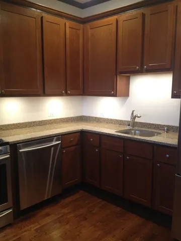 a kitchen with wooden cabinets and a sink