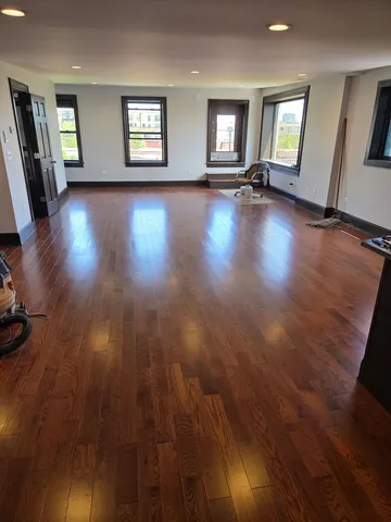 a view of a livingroom with wooden floor and window