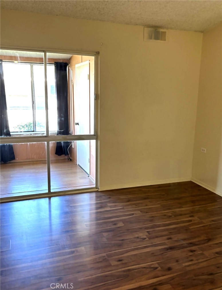 1075 Brookline Road, Unit M9220E Seal Beach, CA 90740 - Photo 11 of 16 a view of empty room with wooden floor and fan