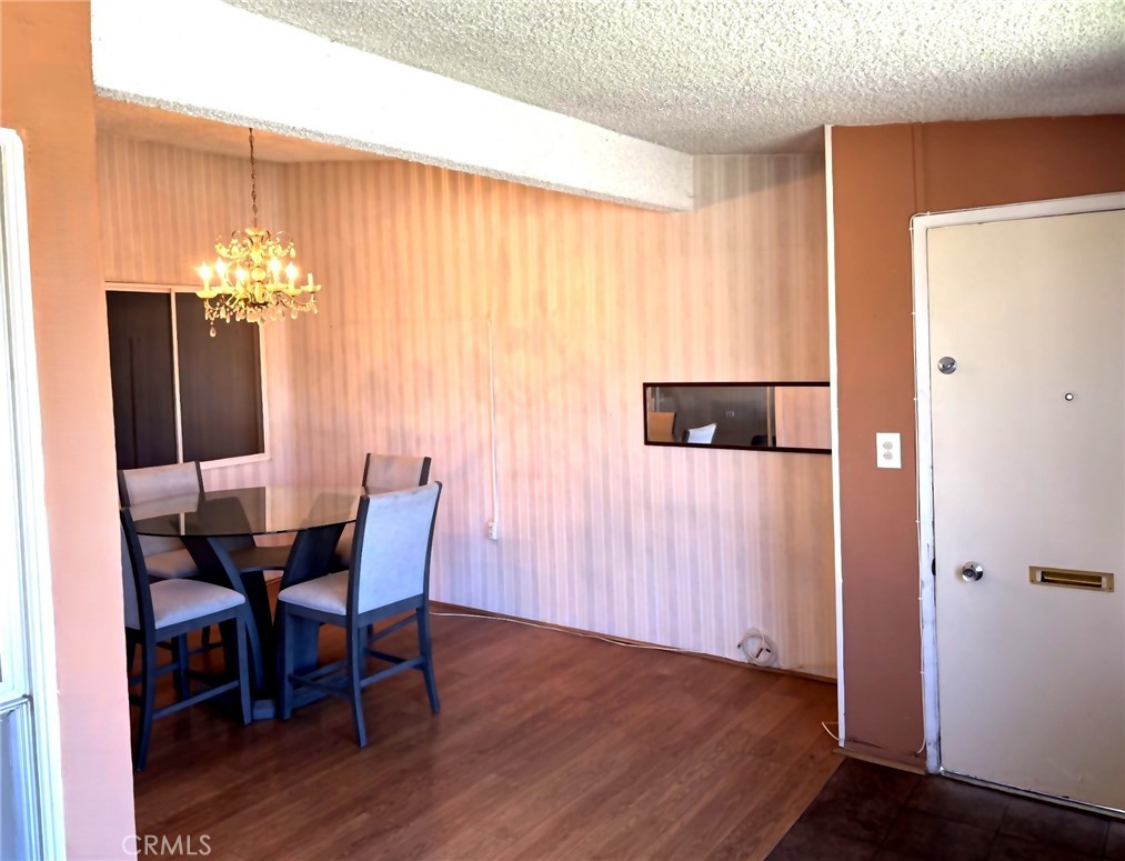1075 Brookline Road, Unit M9220E Seal Beach, CA 90740 - Photo 3 of 16 a view of a dining room with furniture and chandelier