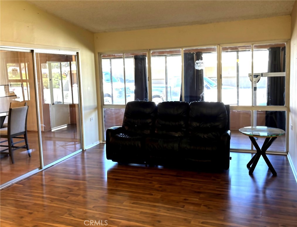 1075 Brookline Road, Unit M9220E Seal Beach, CA 90740 - Photo 5 of 16 a living room with furniture and a large window