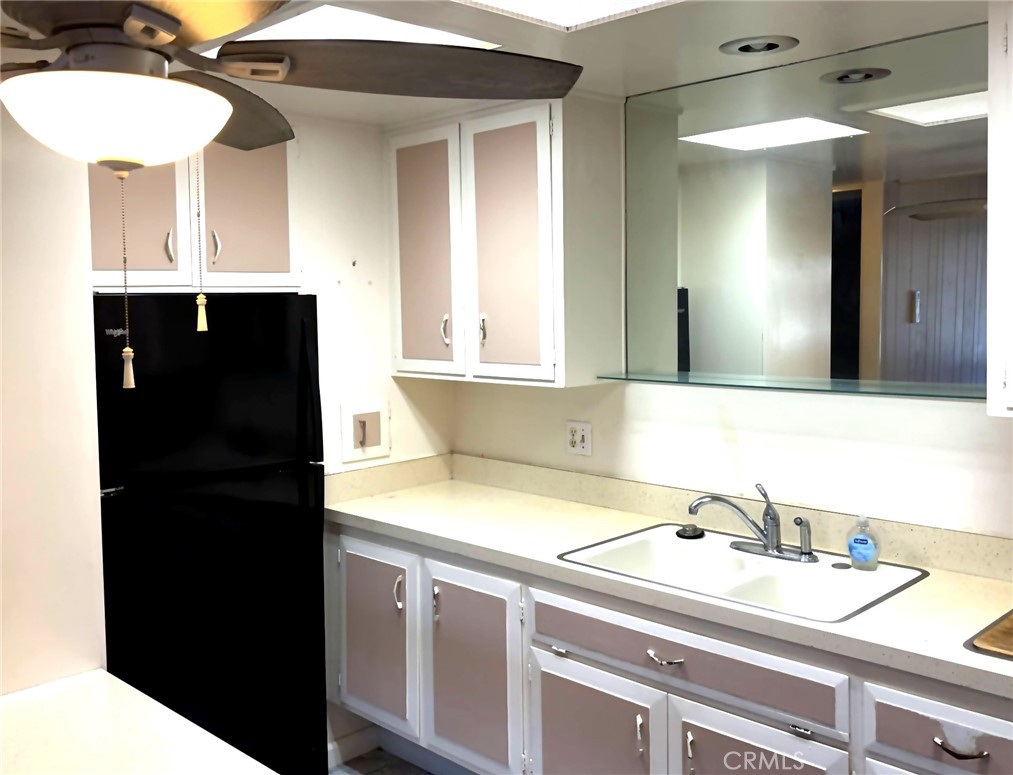 1075 Brookline Road, Unit M9220E Seal Beach, CA 90740 - Photo 7 of 16 a bathroom with a sink and a mirror