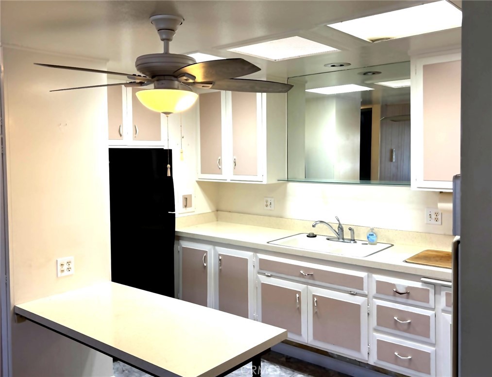 1075 Brookline Road, Unit M9220E Seal Beach, CA 90740 - Photo 8 of 16 a kitchen with a sink a refrigerator and a stove