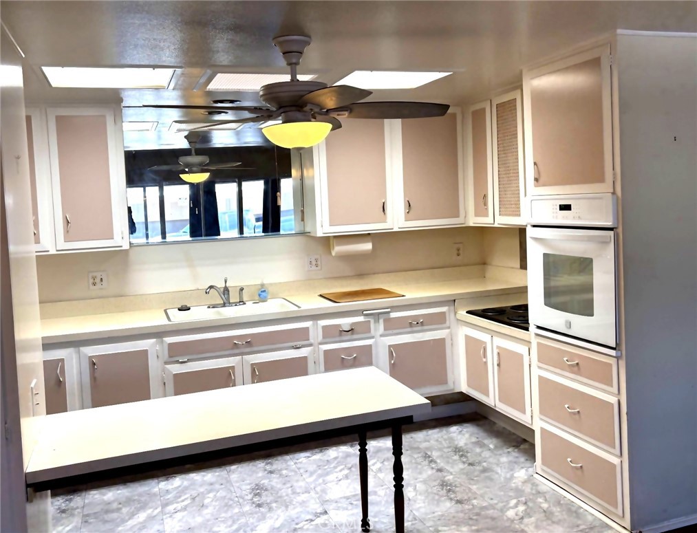 1075 Brookline Road, Unit M9220E Seal Beach, CA 90740 - Photo 9 of 16 a kitchen with stainless steel appliances granite countertop a sink and a stove