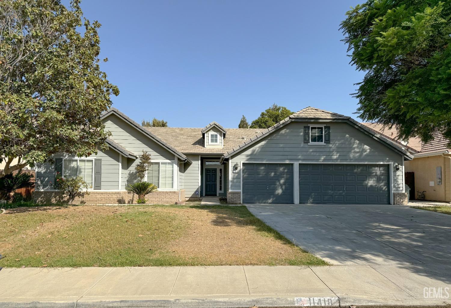 Undisclosed Address Bakersfield, CA 93312 - Photo 1 of 32 a front view of a house with a garden