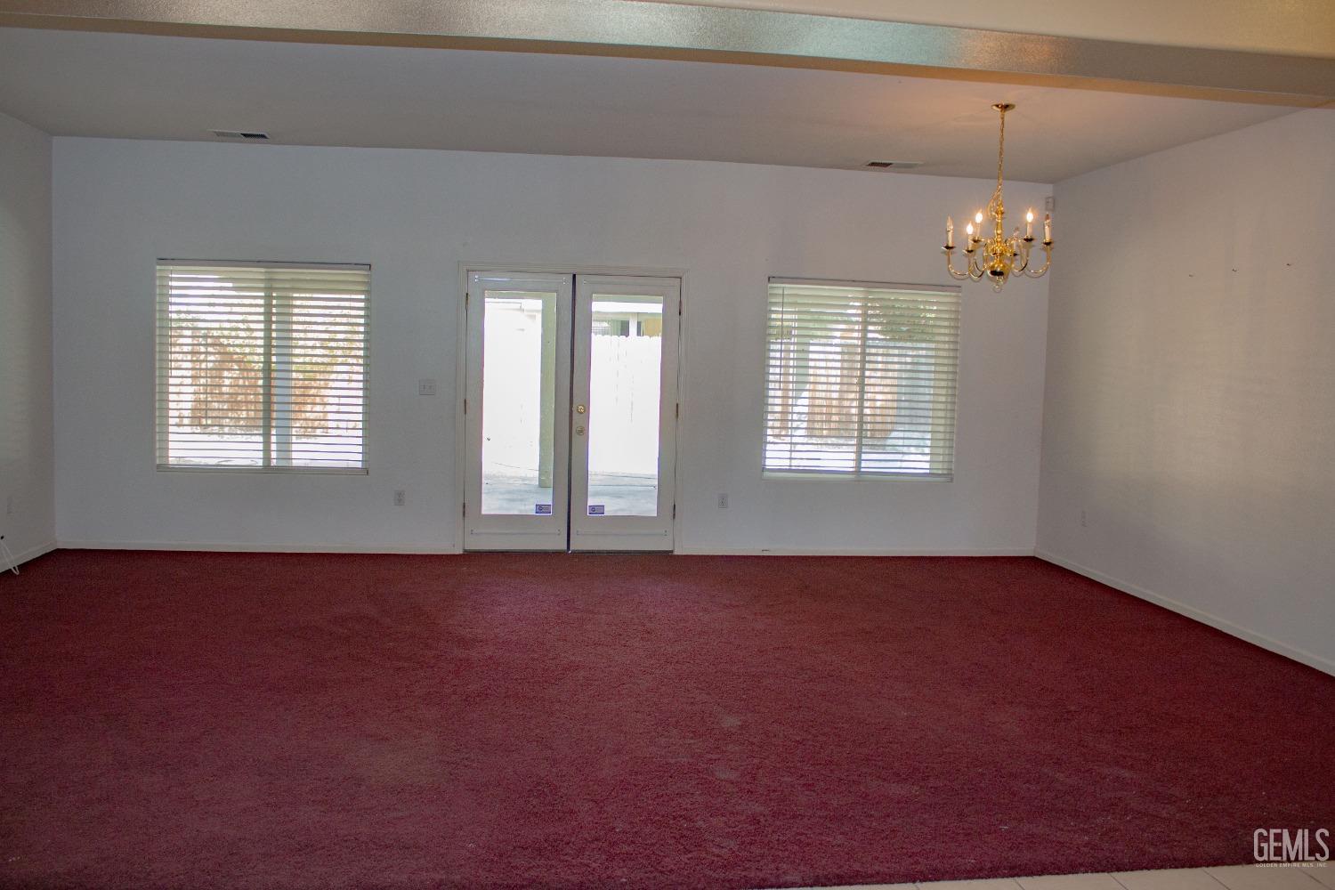 Undisclosed Address Bakersfield, CA 93312 - Photo 12 of 32 an empty room with windows and ceiling fan