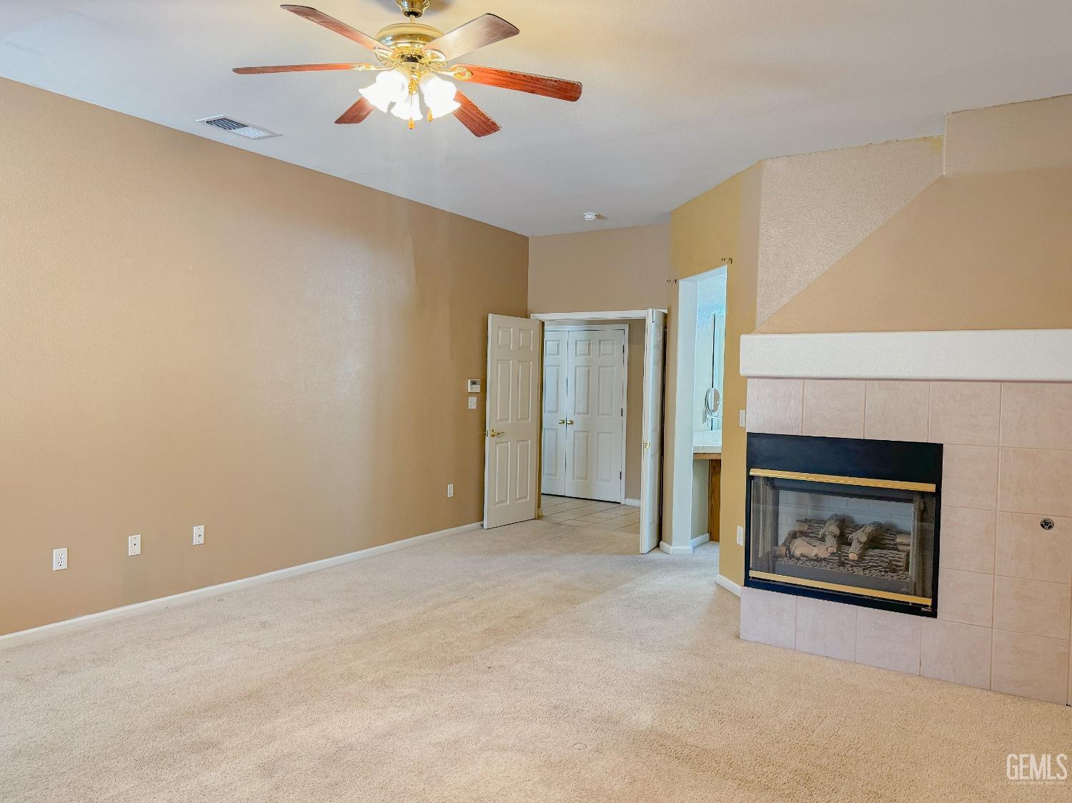 Undisclosed Address Bakersfield, CA 93312 - Photo 14 of 32 a view of an empty room with a fireplace