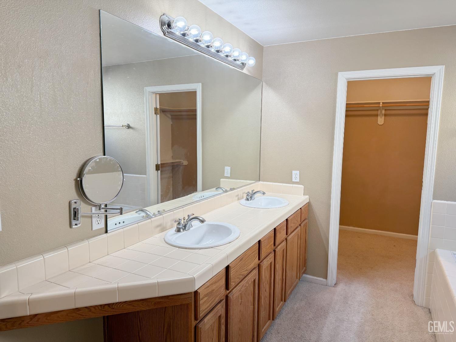 Undisclosed Address Bakersfield, CA 93312 - Photo 15 of 32 a bathroom with a sink and a mirror