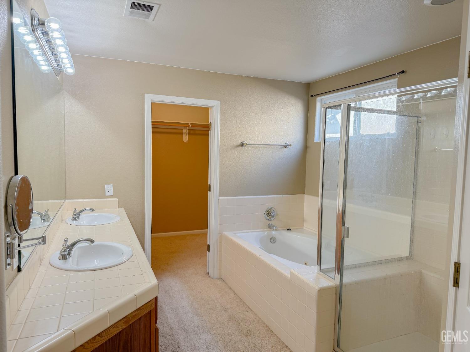 Undisclosed Address Bakersfield, CA 93312 - Photo 16 of 32 a bathroom with a tub sink and mirror