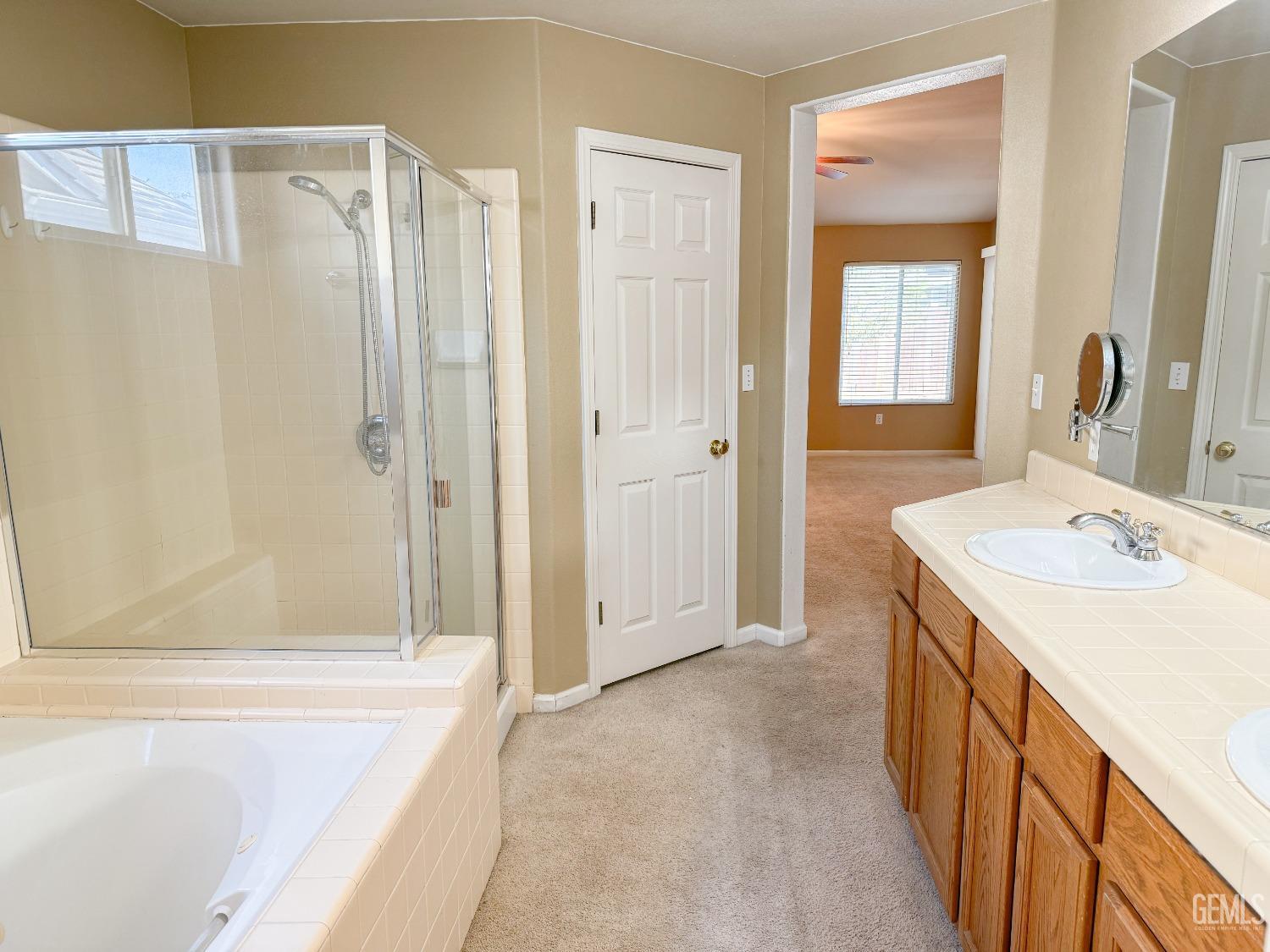 Undisclosed Address Bakersfield, CA 93312 - Photo 17 of 32 a bathroom with a tub sink and mirror