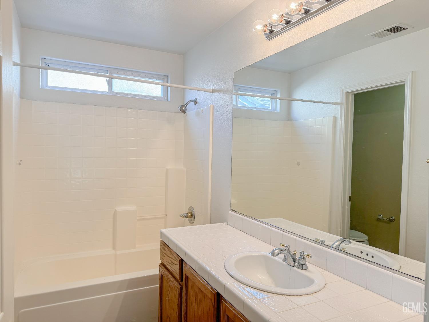 Undisclosed Address Bakersfield, CA 93312 - Photo 20 of 32 a bathroom with a sink and a mirror