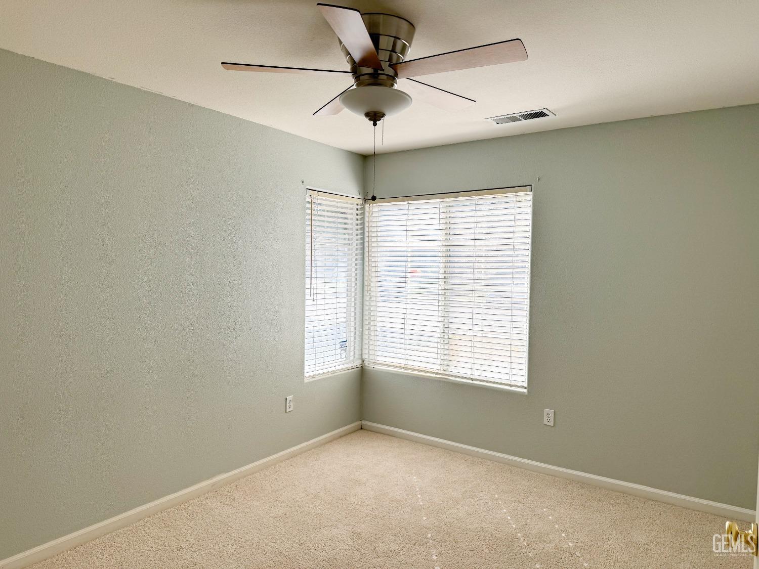 Undisclosed Address Bakersfield, CA 93312 - Photo 21 of 32 an empty room with a window and a fan