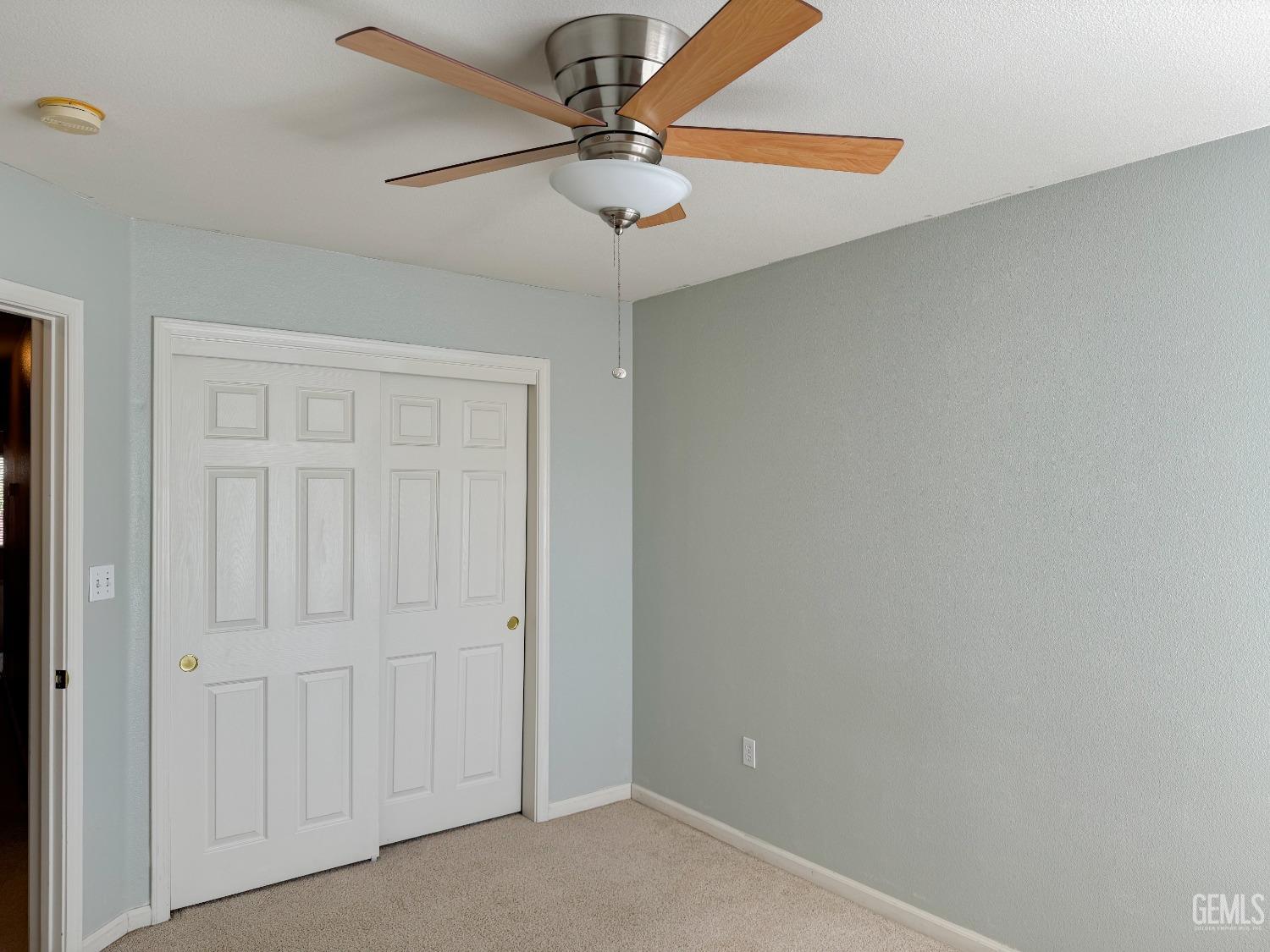 Undisclosed Address Bakersfield, CA 93312 - Photo 22 of 32 an empty room with a ceiling fan and fan