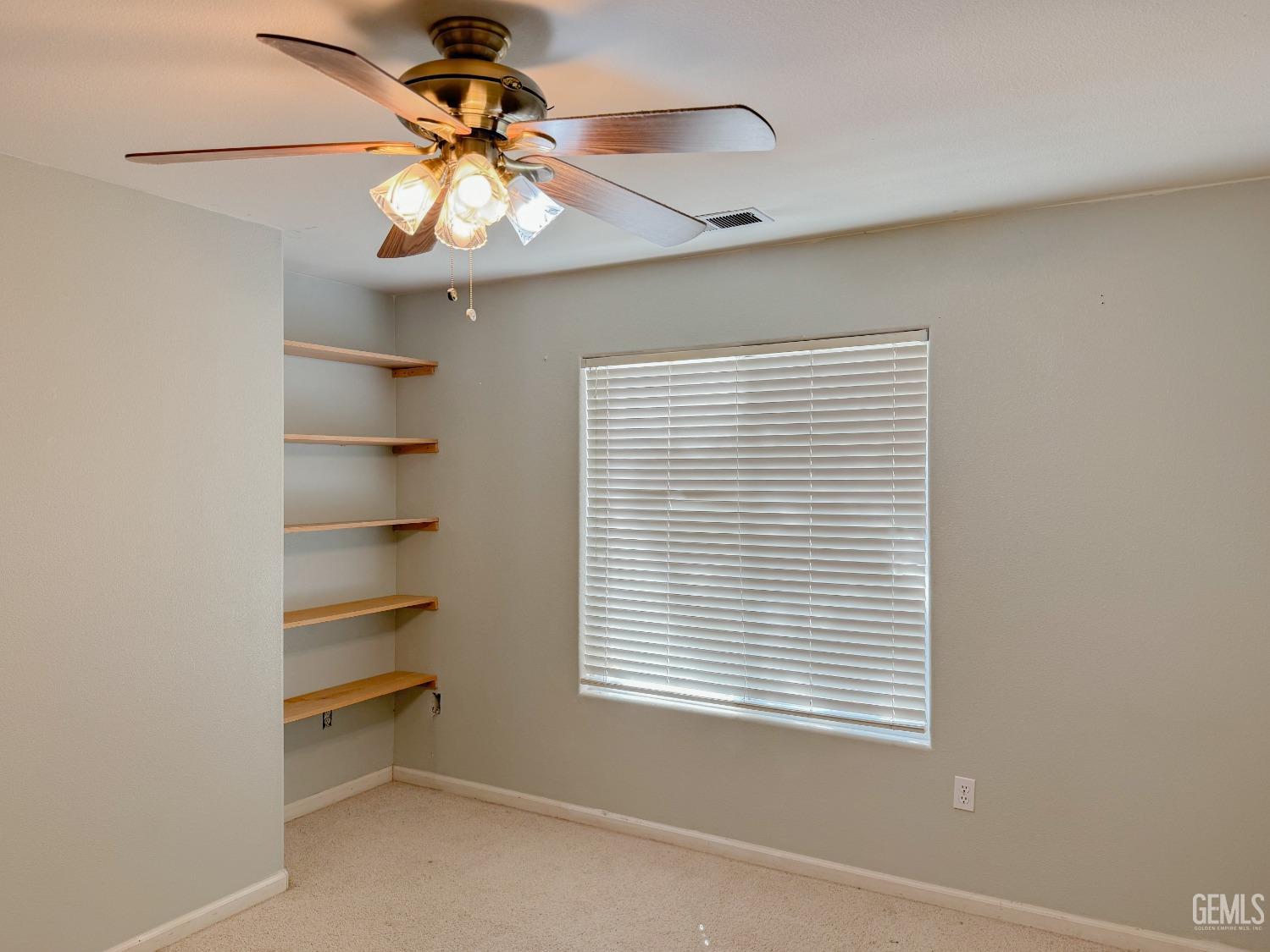 Undisclosed Address Bakersfield, CA 93312 - Photo 24 of 32 a view of a room with a window and a chandelier fan
