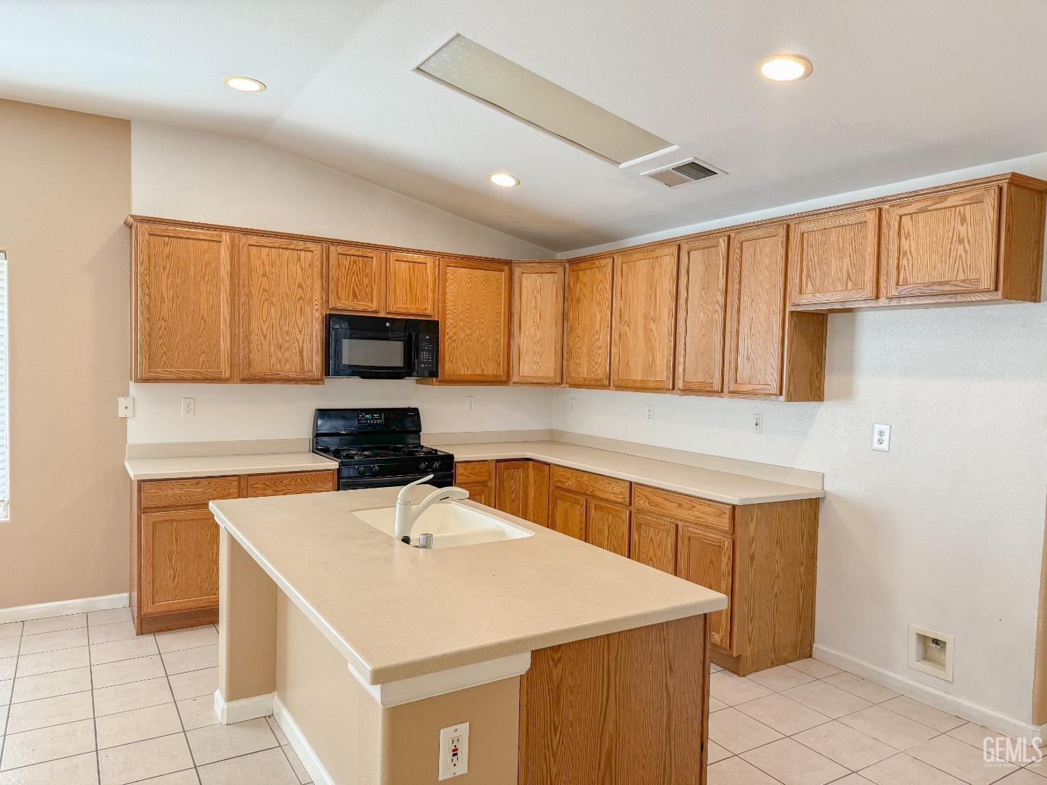 Undisclosed Address Bakersfield, CA 93312 - Photo 6 of 32 a kitchen with a sink a stove a microwave and cabinets