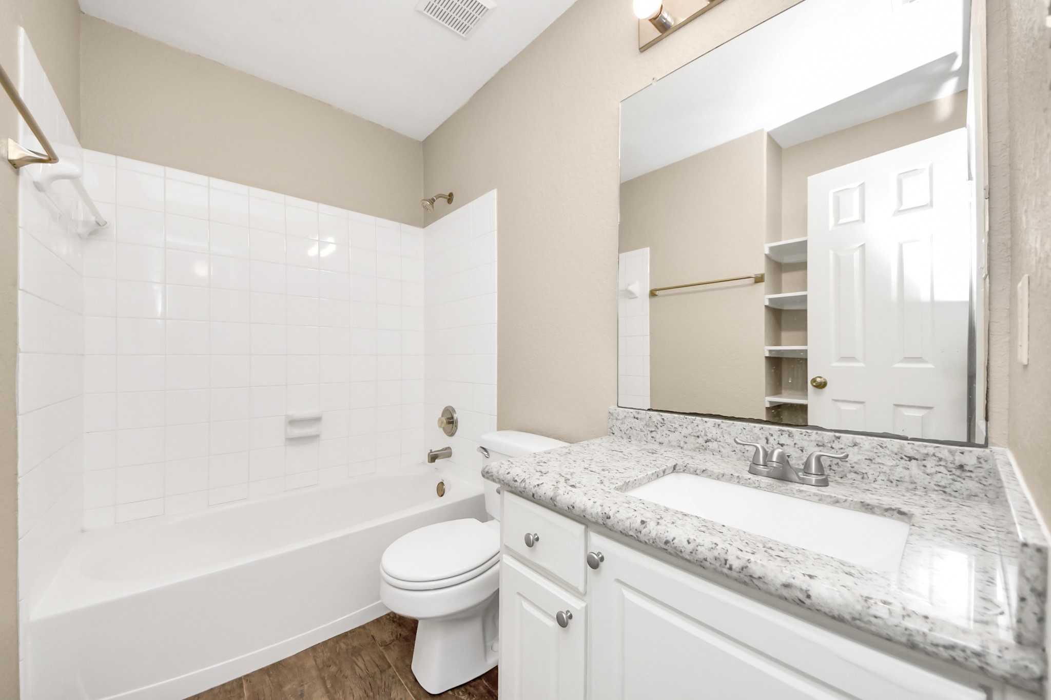 14610 Hazy Ridge Lane Cypress, TX 77429 - Photo 36 of 44 Well-appointed guest bath showcases a granite vanity countertop and custom built-in shelving, blending functionality with attractive design.