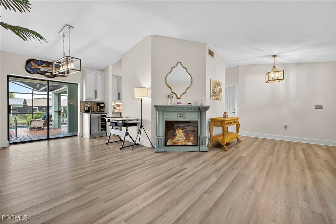1823 Stevenson Road North Fort Myers, FL 33917 - Photo 14 of 32 a view of an empty room with wooden floor fireplace and a window