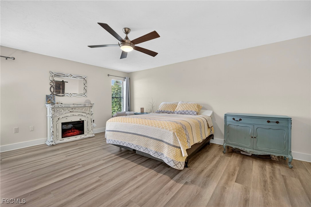 1823 Stevenson Road North Fort Myers, FL 33917 - Photo 16 of 32 a bedroom with a bed and a fireplace