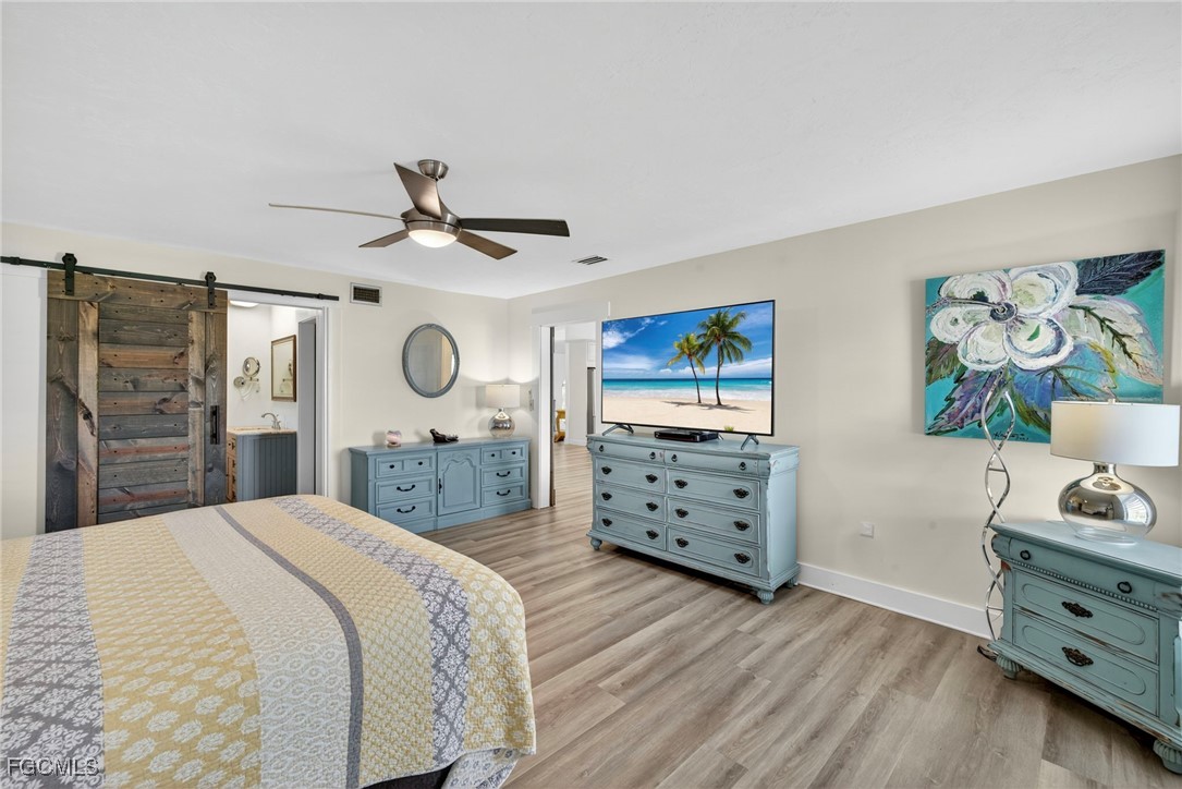 1823 Stevenson Road North Fort Myers, FL 33917 - Photo 17 of 32 a bedroom with a bed a dresser and a closet