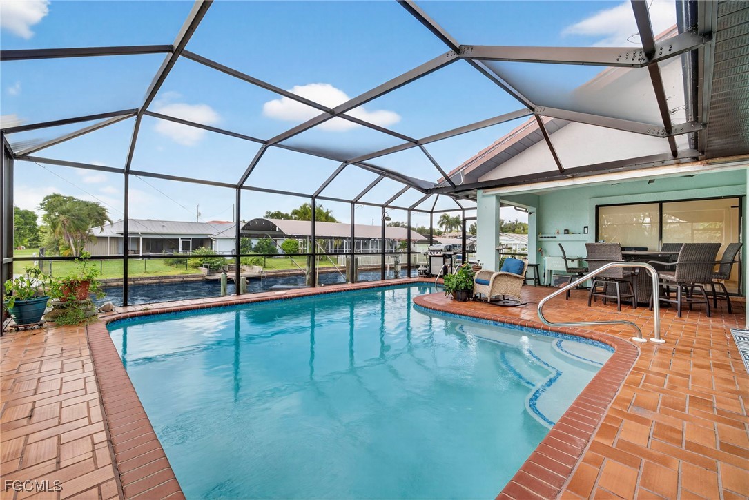 1823 Stevenson Road North Fort Myers, FL 33917 - Photo 26 of 32 a view of a swimming pool with a lounge chairs
