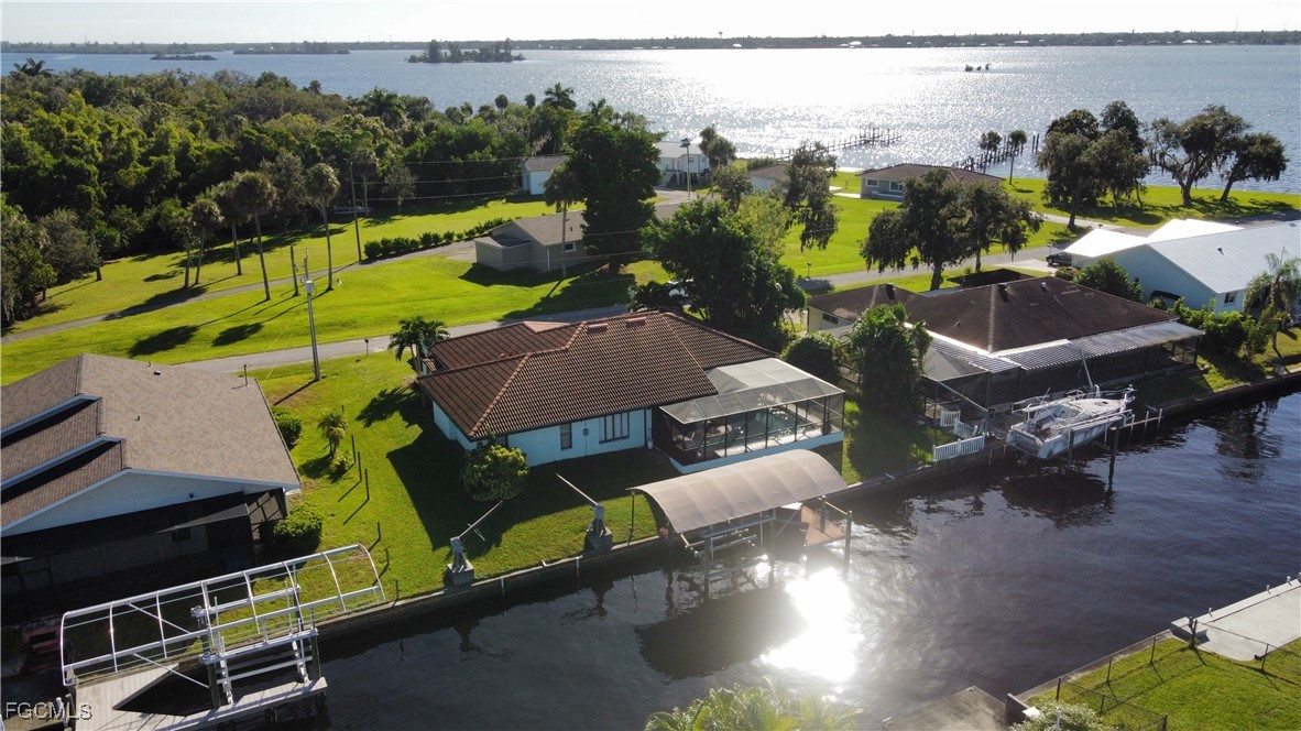 1823 Stevenson Road North Fort Myers, FL 33917 - Photo 32 of 32 an aerial view of a house with a garden and lake view