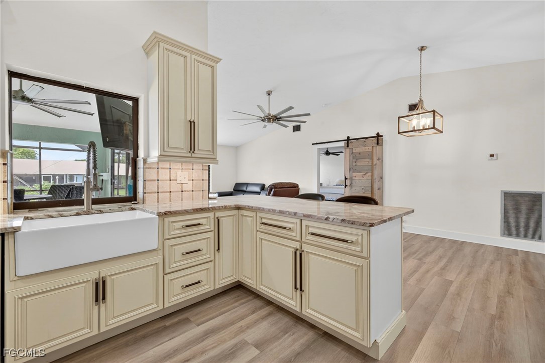 1823 Stevenson Road North Fort Myers, FL 33917 - Photo 5 of 32 a kitchen with white cabinets and white appliances