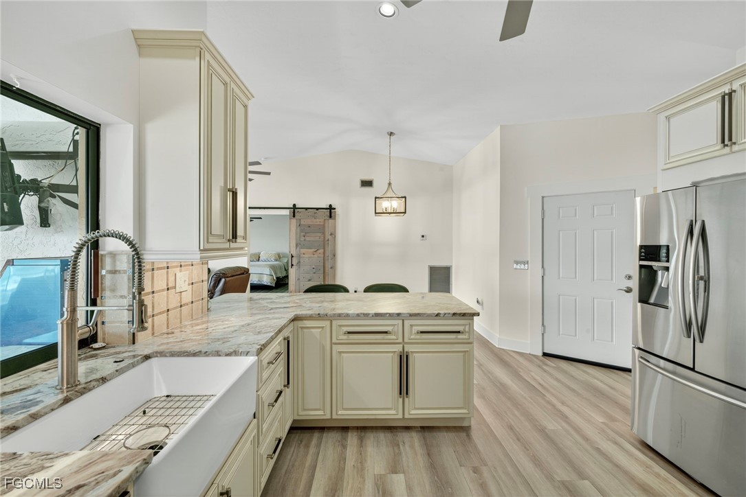 1823 Stevenson Road North Fort Myers, FL 33917 - Photo 6 of 32 a kitchen with a sink stove and refrigerator