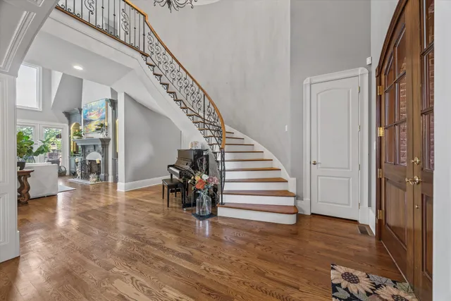 a kitchen with stainless steel appliances granite countertop a stove a sink dishwasher and a dining table with wooden floor