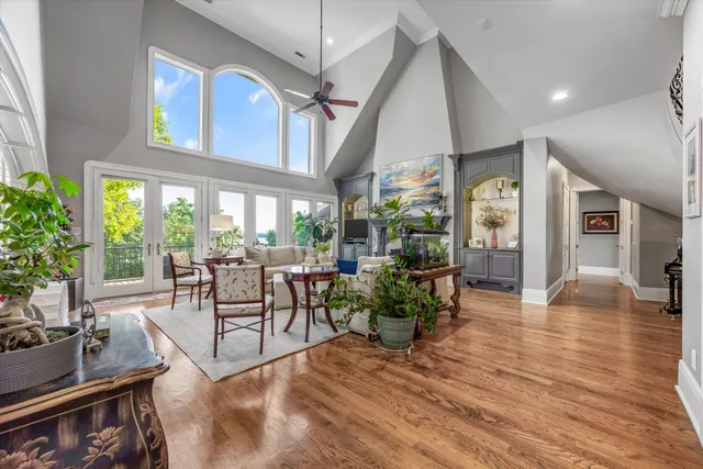 a bedroom with a large bed and a chandelier