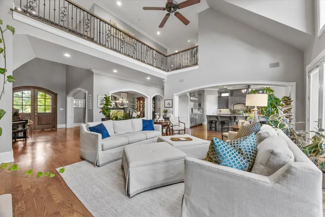 a spacious bathroom with a granite countertop sink a mirror and shower