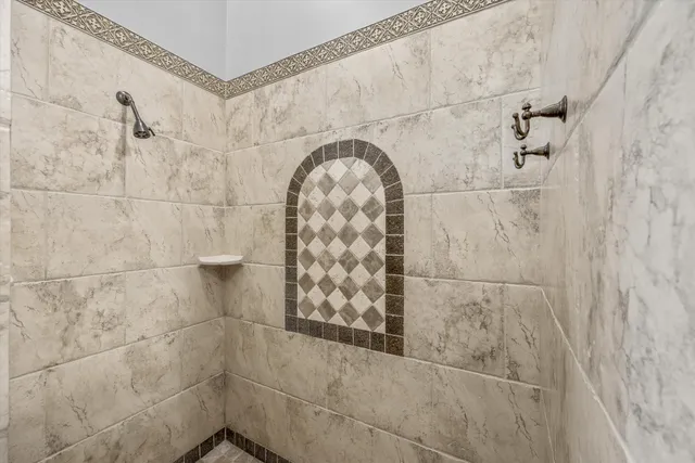 a bathroom with a granite countertop sink a toilet a mirror and shower