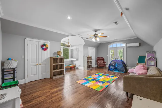 a living room with furniture and a floor to ceiling window