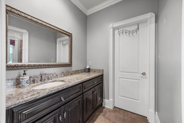 a front view of a house with a yard and potted plants