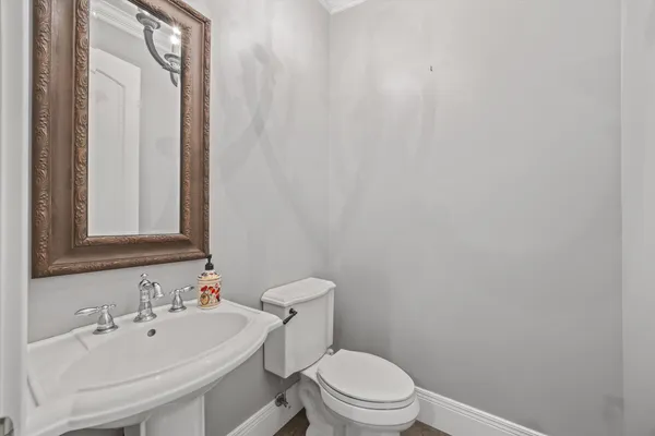 a picture of a room with a white cabinet and a chandelier