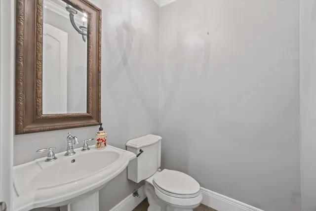 a picture of a room with a white cabinet and a chandelier