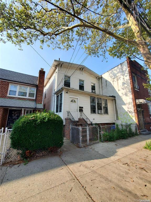 108-49 43rd Avenue Queens, NY 11368 - Photo 2 of 2 a front view of a house with a garden