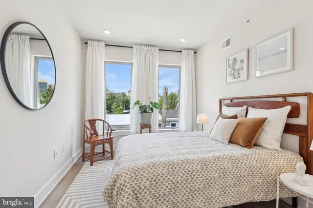 a bedroom with a bed and painting on the wall