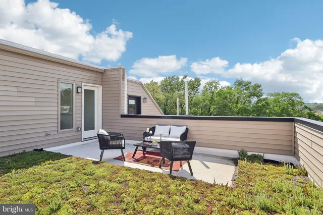 a view of a backyard with sitting area